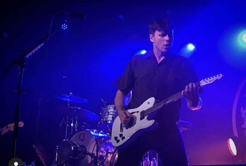 Jimmy East World performing on stage. 