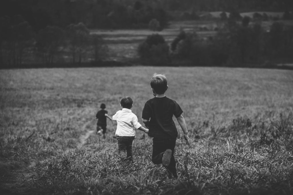 Kids running in a field. 