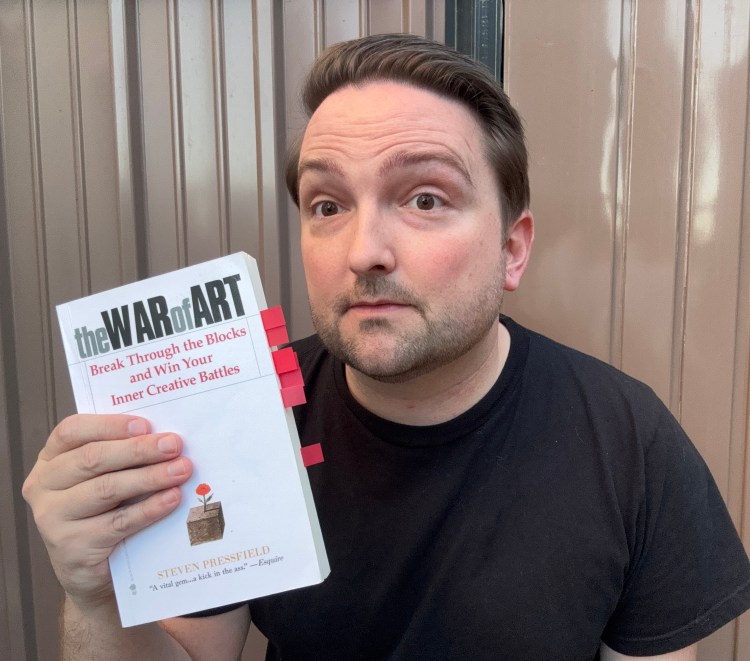 Nick holding the The War of Art book.