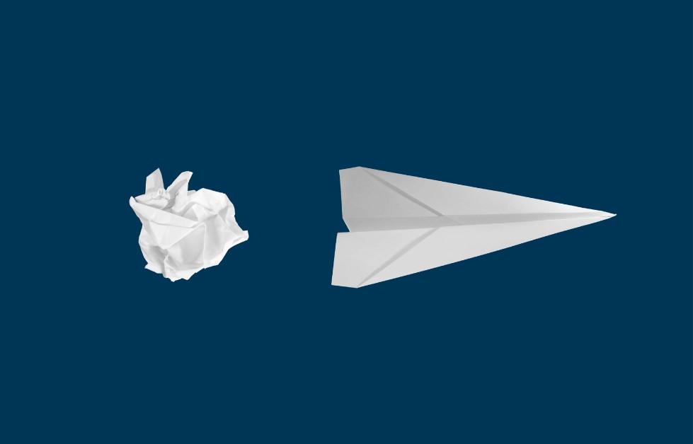 white paper plane on blue background