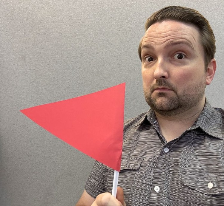 Nick holding a red flag. 